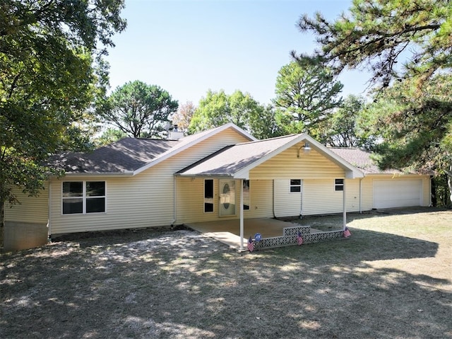 view of front of home featuring a patio area and a garage