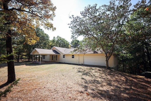 ranch-style home with covered porch and a garage