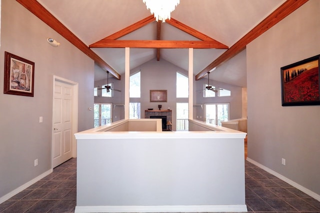 kitchen with lofted ceiling with beams, a fireplace, pendant lighting, and ceiling fan