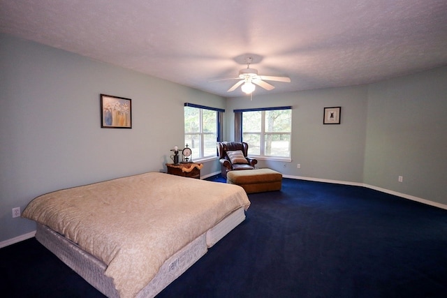 bedroom featuring ceiling fan, carpet flooring, and a textured ceiling