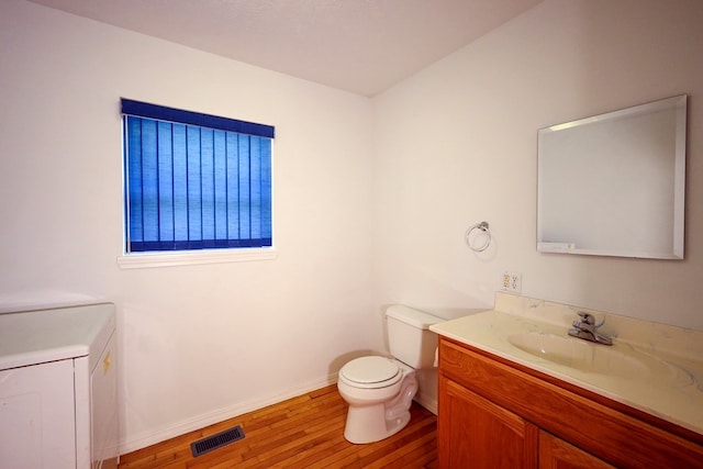 bathroom with vanity, toilet, and wood-type flooring