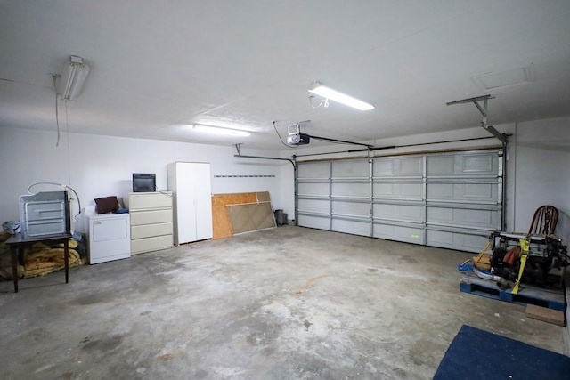 garage featuring washer / dryer and a garage door opener