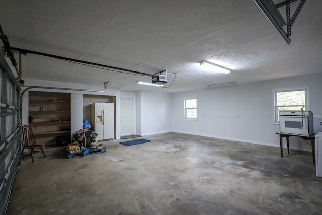 garage with white fridge with ice dispenser and a garage door opener