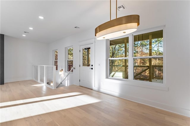 foyer entrance with recessed lighting, visible vents, and wood finished floors