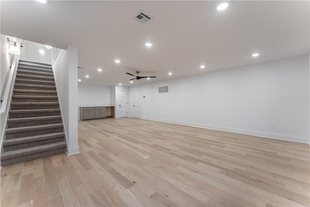 unfurnished living room featuring ceiling fan and light hardwood / wood-style floors