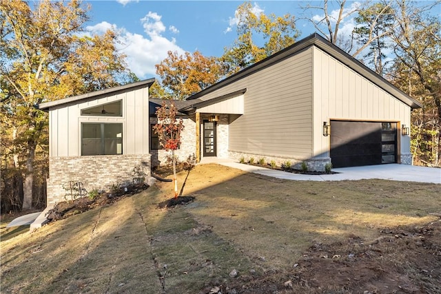 view of home's exterior featuring concrete driveway, brick siding, board and batten siding, and an attached garage