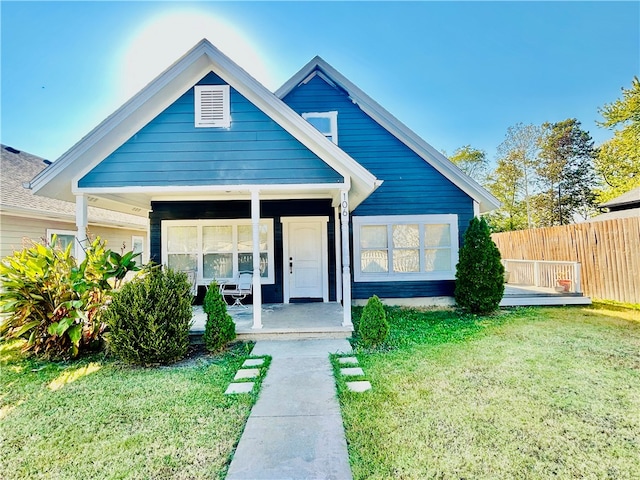 view of front of house featuring a front lawn and covered porch