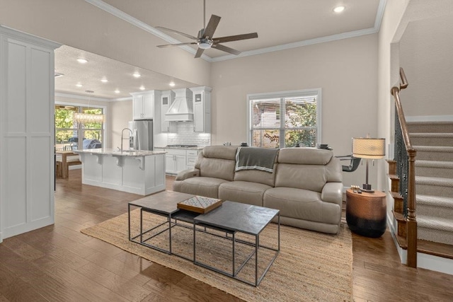 living room with crown molding, hardwood / wood-style floors, and a healthy amount of sunlight