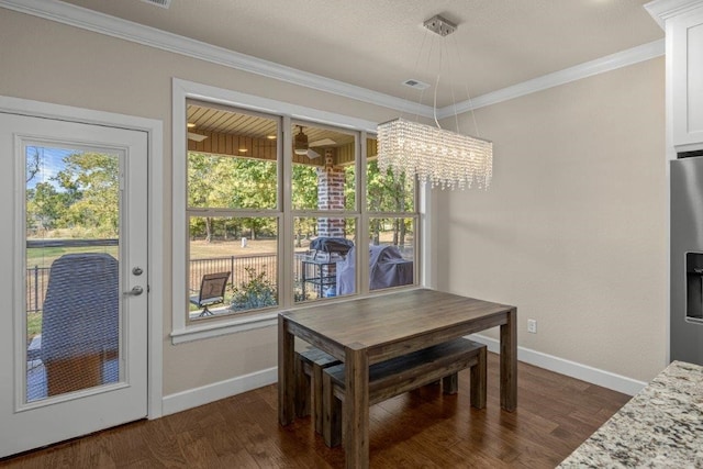 dining area with crown molding, a chandelier, and dark hardwood / wood-style flooring