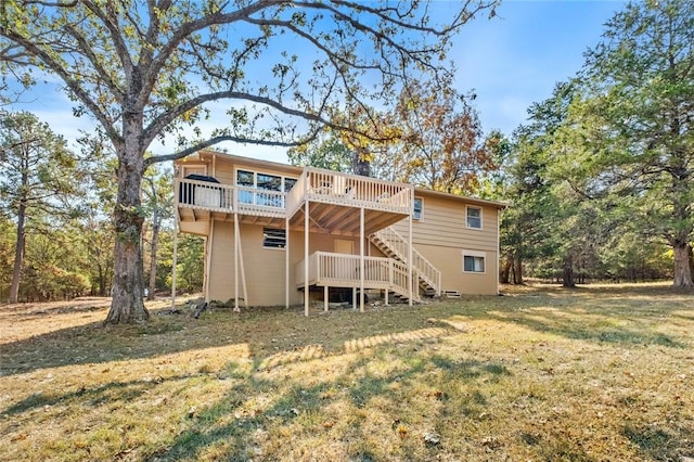 rear view of property featuring a lawn and a wooden deck