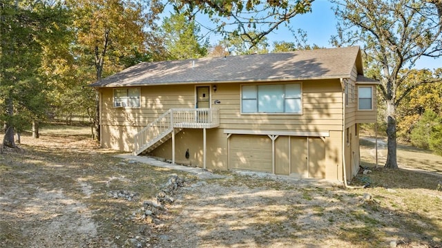 rear view of house featuring a garage