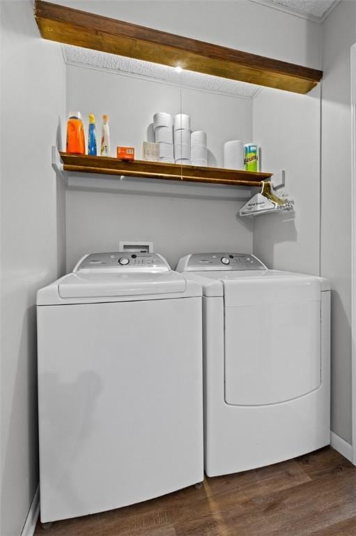 laundry area with washer and dryer and dark hardwood / wood-style floors