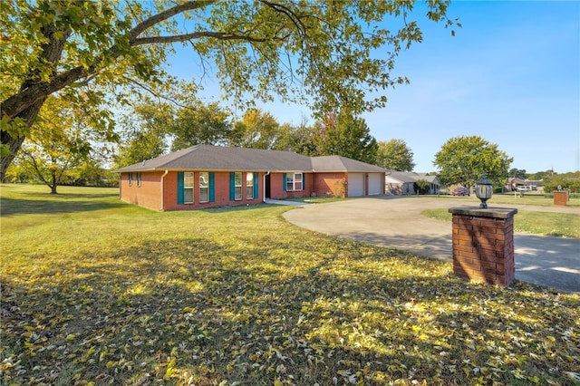 ranch-style home featuring a front yard and a garage