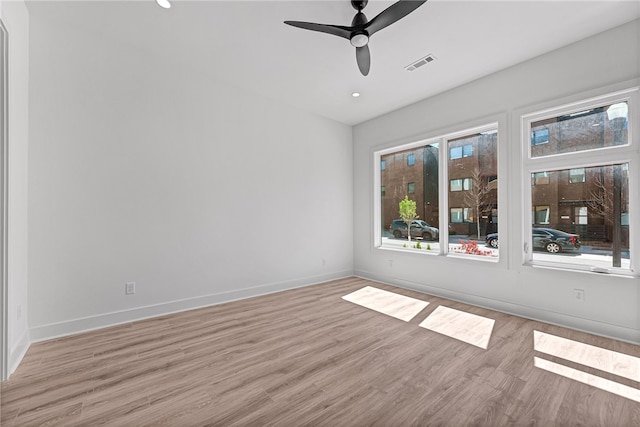 spare room featuring light wood-type flooring and ceiling fan