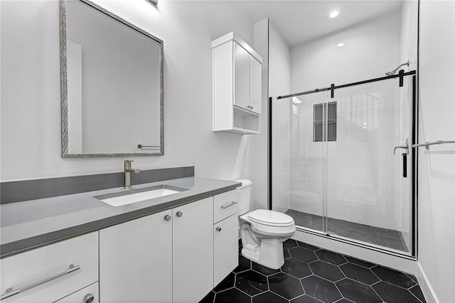 bathroom featuring tile patterned flooring, vanity, walk in shower, and toilet