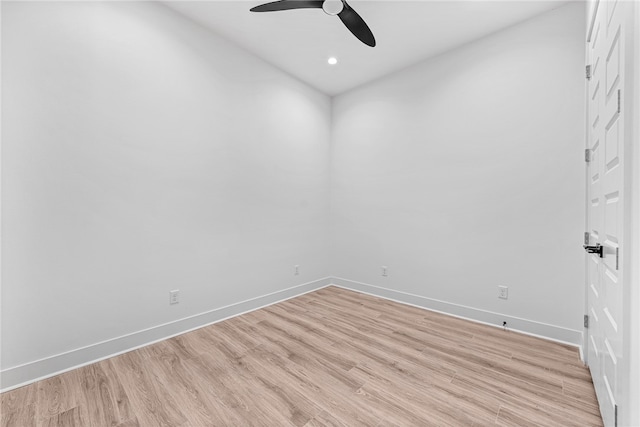 empty room with ceiling fan and light hardwood / wood-style floors