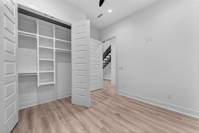 unfurnished bedroom featuring a closet and light hardwood / wood-style floors