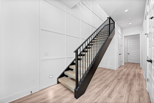 staircase with hardwood / wood-style floors