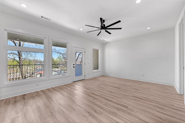 empty room with light hardwood / wood-style flooring and ceiling fan