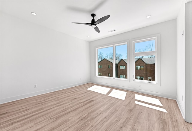 empty room featuring light wood-type flooring and ceiling fan