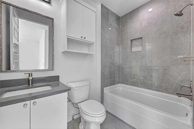 full bathroom featuring vanity, tiled shower / bath combo, and toilet