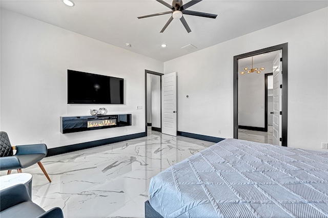 bedroom featuring ceiling fan with notable chandelier