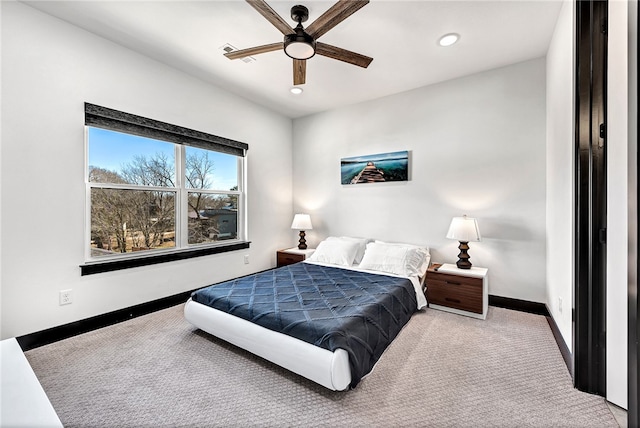 bedroom with ceiling fan and light colored carpet