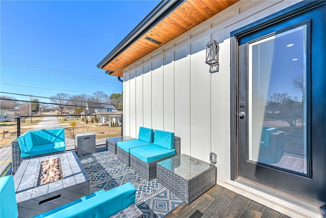 view of patio featuring an outdoor living space with a fire pit