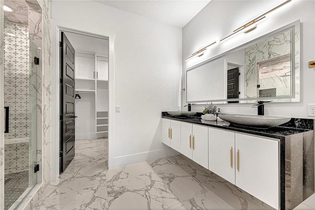 bathroom featuring vanity and a shower with door