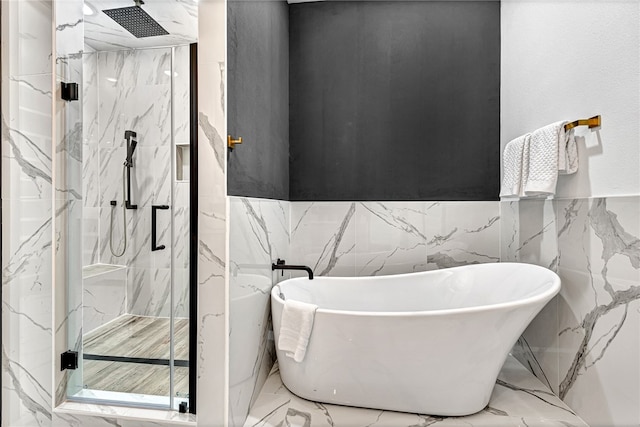 bathroom featuring tile walls and independent shower and bath