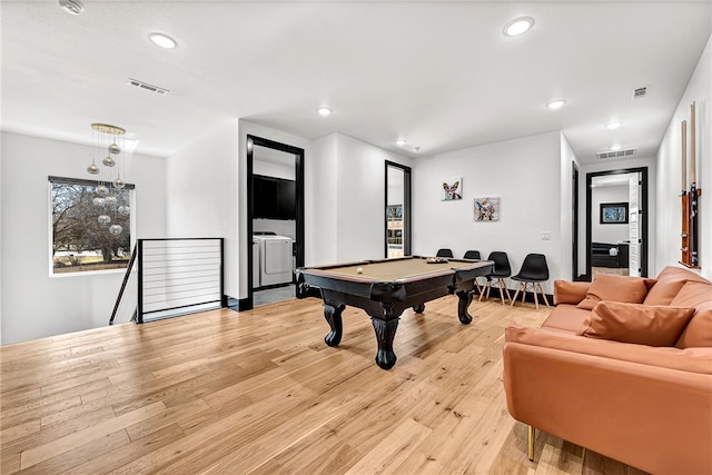 recreation room with pool table, light hardwood / wood-style floors, and washing machine and clothes dryer