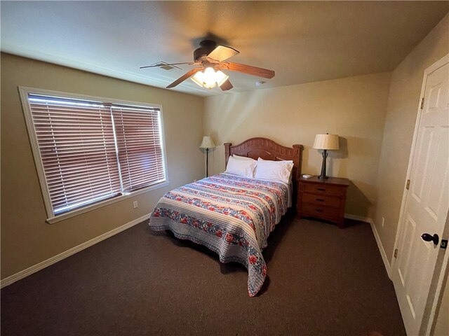 bedroom featuring dark carpet and ceiling fan