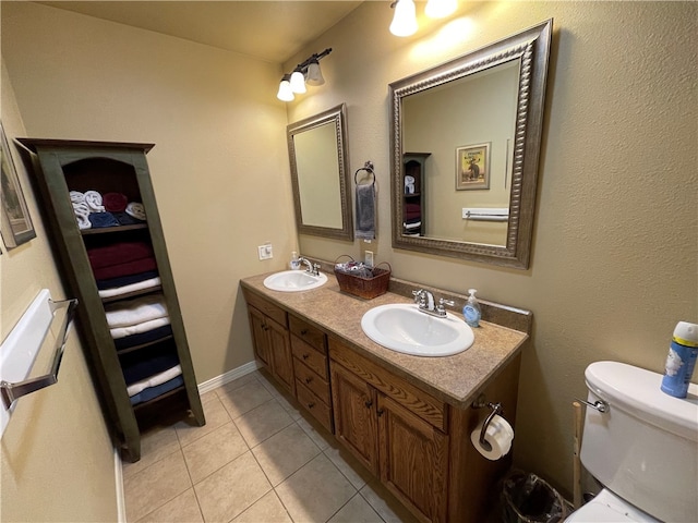 bathroom with vanity, tile patterned flooring, and toilet