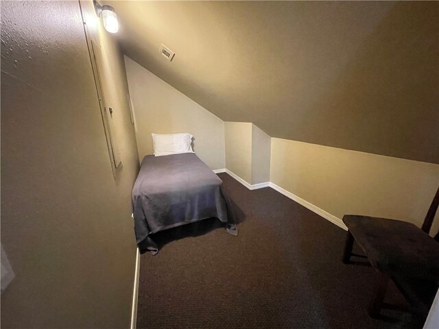 bedroom with lofted ceiling and carpet flooring