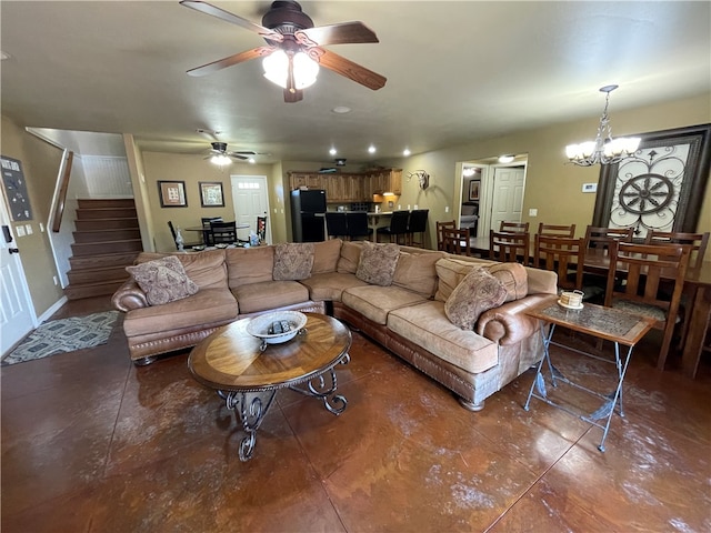 living room featuring ceiling fan with notable chandelier