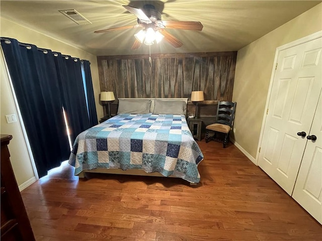 471 Mcphearson Ter, Calico Rock, AR 72519 - bedroom featuring baseboards, ceiling fan, visible vents, wooden walls, and wood finished floors