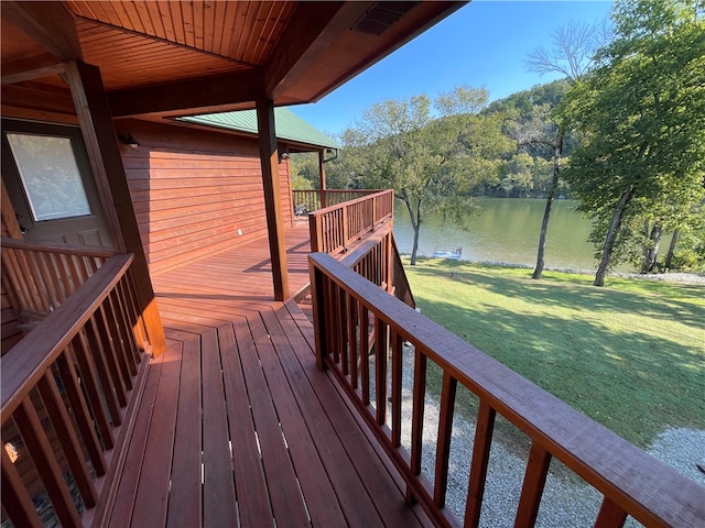 deck featuring a water view and a lawn