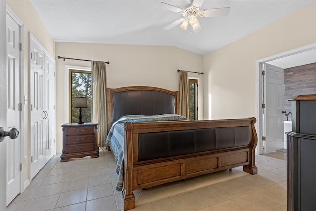 bedroom with vaulted ceiling, light tile patterned floors, and ceiling fan