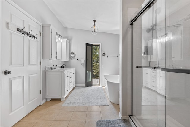 bathroom with lofted ceiling, separate shower and tub, tile patterned floors, and vanity