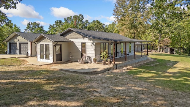 view of home's exterior with a yard, a garage, and a patio area