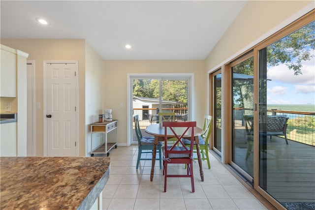 tiled dining area with a water view