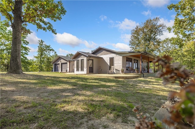 back of property with a yard and a patio area