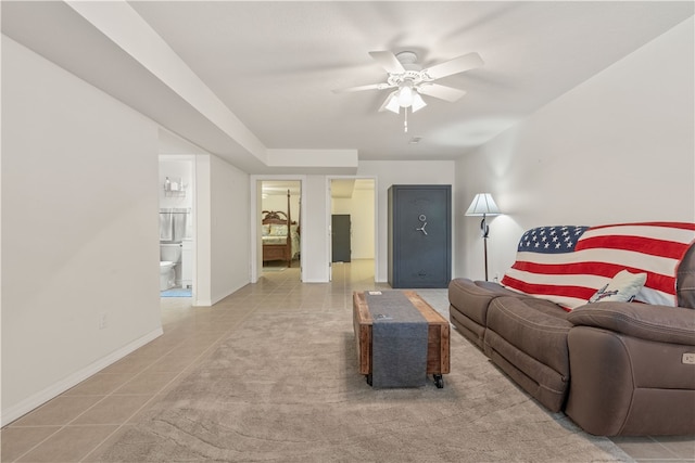 living room with ceiling fan and light tile patterned flooring