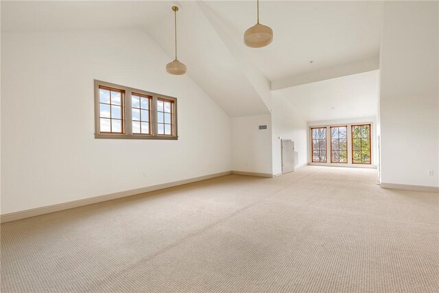 interior space featuring light colored carpet and vaulted ceiling