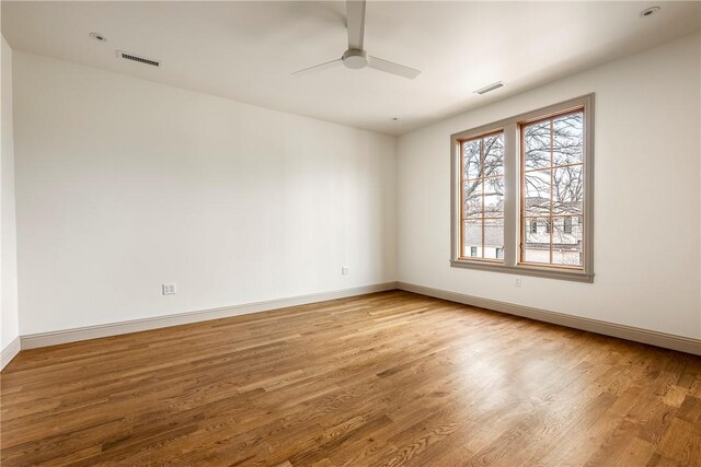 empty room featuring wood-type flooring and ceiling fan