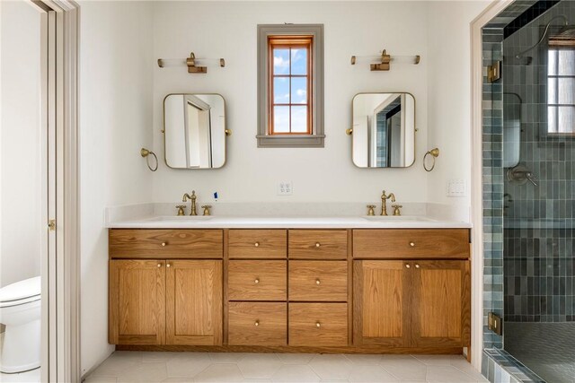 bathroom featuring a shower with door, toilet, tile patterned floors, and vanity