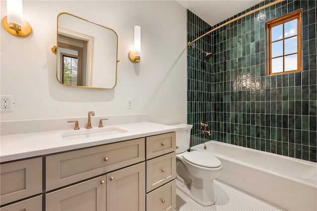 full bathroom with vanity, toilet, tiled shower / bath, and tile patterned flooring