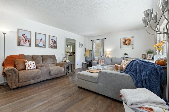 living room featuring a textured ceiling and dark wood-type flooring