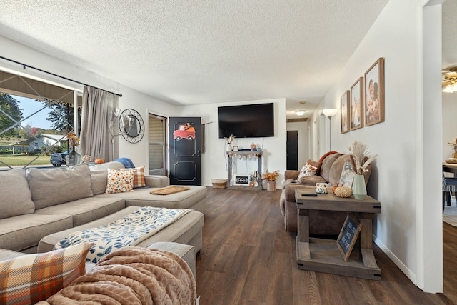 living room with a textured ceiling and dark wood-type flooring