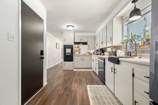 kitchen featuring pendant lighting, white cabinets, a textured ceiling, dishwasher, and dark hardwood / wood-style flooring